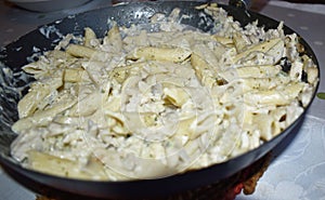 Close up shot of pasta in a black pan