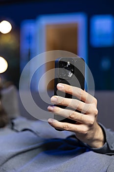 Close up shot of phone used by person laying down, chatting with mates online