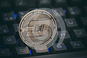 Physical Dash Coin Between The Keys Of A Computer Keyboard