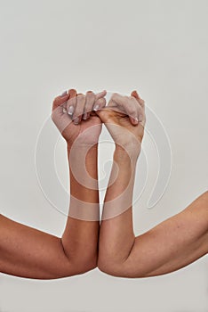 Close up shot of pinky swear. Promise hand gesture isolated over light background