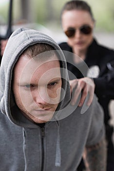 close-up shot of policewoman catching shoulder of