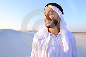 Close-up shot of portrait of happy sheik boy standing in middle