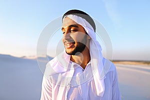 Close-up shot of portrait of happy sheik boy standing in middle