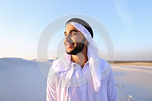 Close-up shot of portrait of happy sheik boy standing in middle