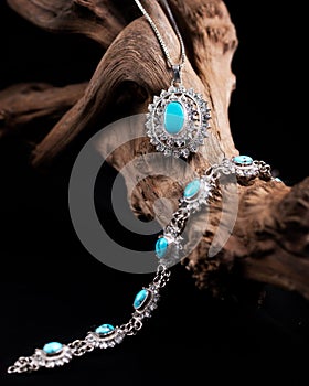 Close-up shot of a precious bracelet and necklace with turquoise gem