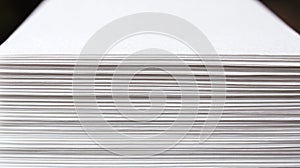 Stack of white paper sheets isolated on black background