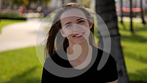 Close up shot of a pretty girl under palm trees at the beach