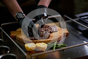 Close-up shot, a professional chef expertly prepares a delicious steak using modern cooking techniques, showcasing