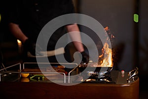 Close-up shot, a professional chef expertly prepares a delicious steak using modern cooking techniques, showcasing