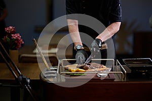 Close-up shot, a professional chef expertly prepares a delicious steak using modern cooking techniques, showcasing