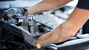 Close Up Shot of a Professional Mechanic Working on Vehicle in Car Service. Engine Specialist Fixi