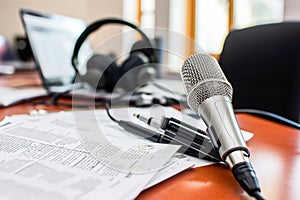 Close-up shot of a professional microphone in the office of a radio or podcast professional