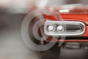 Close up shot of red collectible toy car head lamps