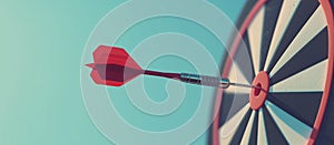 Close up shot red darts arrows in the target of dartboard center on dark blue sky background. Business target or goal