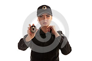 Close-up shot of a redheaded female police officer posing for the camera isolated on white background.