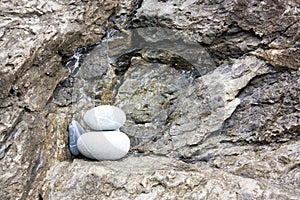 Close-up shot of rocky hillside with balancing stones in Cinqueterre, Italy