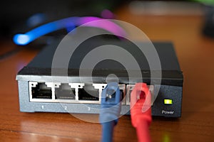 Close-up shot of a router - a red cable is connected next to the blue Ethernet cable. Concept of cabling, internet network,