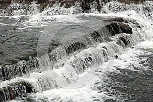 Close up shot of a rushing stream in forest creek.