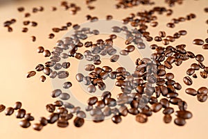 Close-up shot of scoop and roasted coffee beans spilled