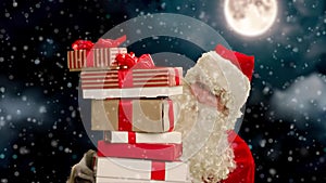 Close up shot of senior bearded man in santa clause outfit carrying gift boxes, isolated against the background of the