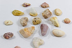 Close-up shot of several colorful stones that collected from beach on white background