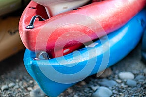 Close up shot of several Kayaks stowed by the sea shore