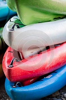 Close up shot of several Kayaks stowed by the sea shore