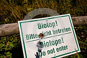 a close up shot of a sign for forbidden entering a biotope in a natural reserve in Germany