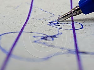 Close-up shot of signature and ink pen on a white background