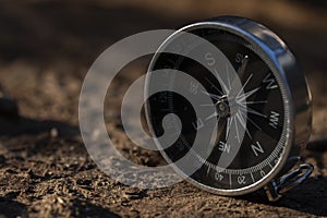 Close up shot of a silver metal compass always pointing it's needle towards North