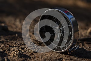 Close up shot of a silver metal compass always pointing it's needle towards North