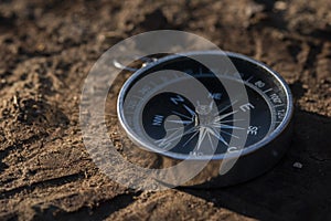 Close up shot of a silver metal compass always pointing it's needle towards North