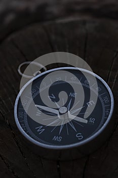 Close up shot of a silver metal compass always pointing it's needle towards North