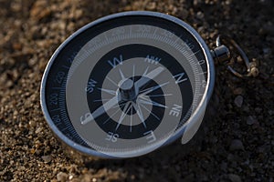 Close up shot of a silver metal compass always pointing it's needle towards North