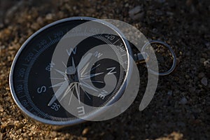 Close up shot of a silver metal compass always pointing it's needle towards North