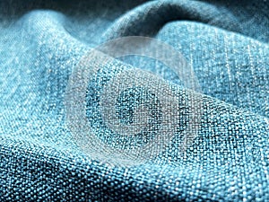 Close up shot of solid blue denim fabric with a soft and lightweight texture