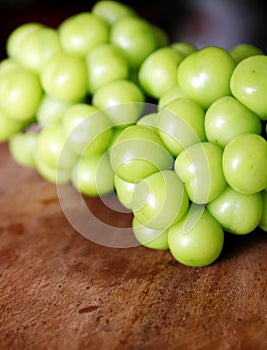 Close-up shot of some string of green grapes.