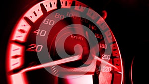 Close up shot of a speed meter in a car with red light speed at 220 Km/H in concept racing car