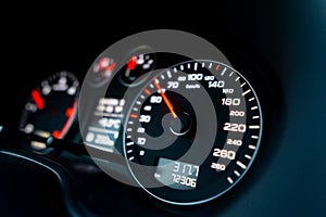 Close up shot of a speedometer in a car. Car dashboard. Dashboard details with indication lamps.Car instrument panel. Dashboard