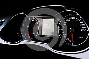 Close up shot of a speedometer in a car. Car dashboard. Dashboard details with indication lamps.Car instrument panel. Dashboard wi