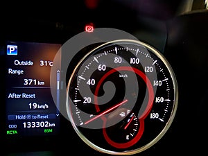 Close up shot of a speedometer in a car. Car dashboard with details with indication lamps and instrument panel. Modern interior.