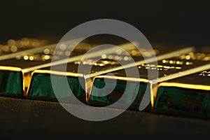 Close up shot of stacked 999.9 pure gold bar ingot on a black background