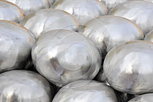 Close-up shot of stainless steel alms bowl arranged on the floor In a Buddhist ordination ceremony in a temple in India