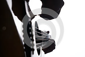 Close up shot of strings and guitarist hands playing acoustic guitar