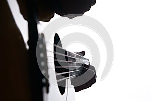 Close up shot of strings and guitarist hands playing acoustic guitar