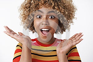 Close-up shot of surprised upbeat and excited cute african american woman won amazing gift gonna spend awesome winter