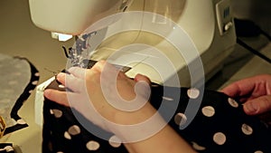 Close up shot of a tailor behind a sewing machine