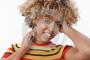 Close-up shot of tender and sensual attractive gentle african american stylish woman with fair afro haircut and pierced