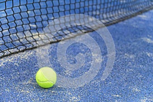 Close up shot of a tennis ball next to the net
