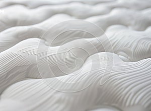 A close-up shot of the texture and pattern on a mattress, highlighting its softness and comfort for sleeping. The